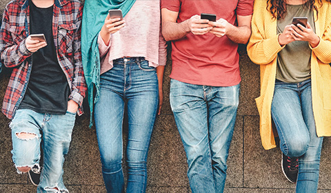 A group of people on their phones